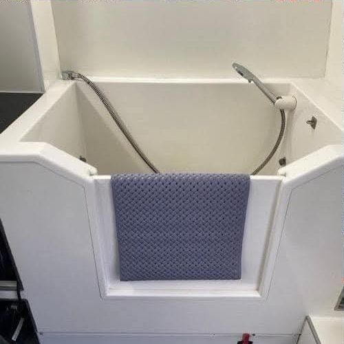 Walk-in dog bath with shower inside the van